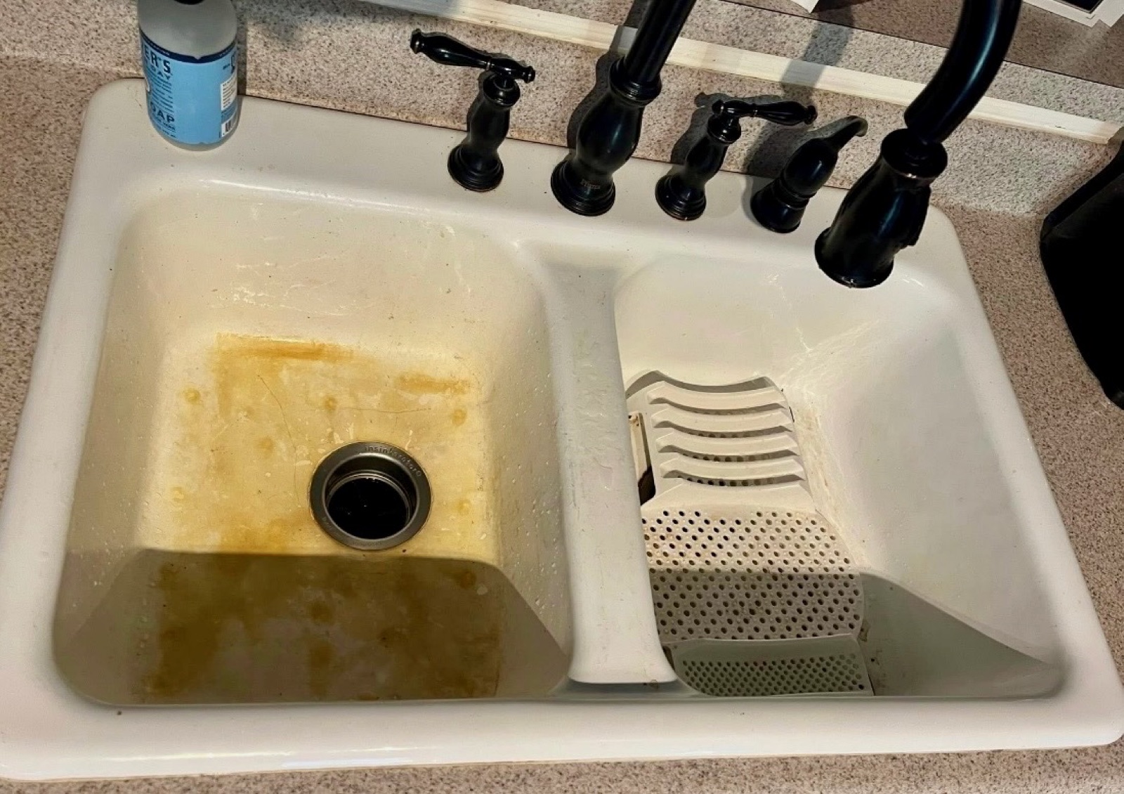 Kitchen sink with rust and staining before deep cleaning